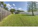 Spacious backyard with view of home and wooden fence at 6642 Stewart N Ave, St Petersburg, FL 33702