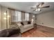 Living room with hardwood floors, couch, and ceiling fan at 6642 Stewart N Ave, St Petersburg, FL 33702