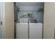 Laundry room with washer, dryer, and shelving for storage at 6642 Stewart N Ave, St Petersburg, FL 33702