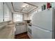 White kitchen features ample counter space, wood floors, and a refrigerator at 6642 Stewart N Ave, St Petersburg, FL 33702