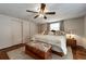 Bright bedroom with wood floors, ceiling fan, and ample closet space at 6642 Stewart N Ave, St Petersburg, FL 33702
