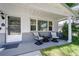 Relaxing front porch with mid-century modern furniture at 6642 Stewart N Ave, St Petersburg, FL 33702