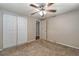 Simple bedroom with neutral walls, ceiling fan, and double closets at 6642 Stewart N Ave, St Petersburg, FL 33702
