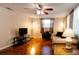 Living room with hardwood floors, a TV, and comfy seating at 6642 Stewart N Ave, St Petersburg, FL 33702