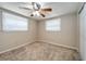 Bedroom with neutral walls, ceiling fan, and two windows at 6642 Stewart N Ave, St Petersburg, FL 33702
