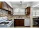 Kitchen with white appliances and stone backsplash at 6635 Stewart N Ave, St Petersburg, FL 33702