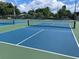 Well-maintained pickleball courts with blue surface and green boundaries at 6635 Stewart N Ave, St Petersburg, FL 33702