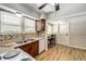 Kitchen with wood cabinets, a double sink and vinyl flooring at 6635 Stewart N Ave, St Petersburg, FL 33702