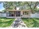 Charming bungalow with screened porch, brick accents, and a well-manicured lawn at 6635 Stewart N Ave, St Petersburg, FL 33702