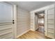Bright hallway with white walls and wood-look floors at 6635 Stewart N Ave, St Petersburg, FL 33702