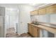 Kitchen with light wood cabinets and double sink at 14904 Old Dixie Hwy, Hudson, FL 34667