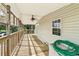 Wooden deck with a ceiling fan and screened enclosure at 14904 Old Dixie Hwy, Hudson, FL 34667