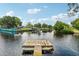 Relaxing waterfront view with a wooden dock, perfect for enjoying the Florida sunshine at 14904 Old Dixie Hwy, Hudson, FL 34667