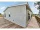 Tan vinyl-sided house with a wooden deck and landscaping at 14904 Old Dixie Hwy, Hudson, FL 34667