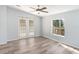 Primary bedroom with vinyl flooring and French doors at 14904 Old Dixie Hwy, Hudson, FL 34667