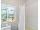 Clean bathroom with shower and nautical themed window at 14904 Old Dixie Hwy, Hudson, FL 34667