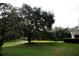 Spacious backyard with lush green grass and large oak tree at 23337 Lake Lindsey Rd, Brooksville, FL 34601