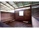Empty rustic barn stall with wood shavings at 23337 Lake Lindsey Rd, Brooksville, FL 34601