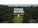Two story home with metal roof and lush landscaping at 23337 Lake Lindsey Rd, Brooksville, FL 34601