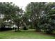 Mature oak trees and lush lawn create a tranquil setting at 23337 Lake Lindsey Rd, Brooksville, FL 34601