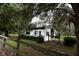 White barn with black trim and green shrubs at 23337 Lake Lindsey Rd, Brooksville, FL 34601