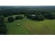 Aerial view of a large property with home and equestrian facilities at 23337 Lake Lindsey Rd, Brooksville, FL 34601