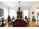 Elegant dining room featuring a large wood table and chandelier at 23337 Lake Lindsey Rd, Brooksville, FL 34601