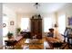 Living room with hardwood floors, antique furniture, and two comfy daybeds at 23337 Lake Lindsey Rd, Brooksville, FL 34601