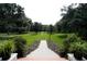 Landscaped front yard with walkway leading to home at 23337 Lake Lindsey Rd, Brooksville, FL 34601