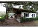 Rustic horse stable with white exterior and covered area at 23337 Lake Lindsey Rd, Brooksville, FL 34601