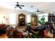 Relaxing living room with a fireplace, hardwood floors, and leopard print rug at 23337 Lake Lindsey Rd, Brooksville, FL 34601