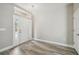 Light and airy entryway with gray laminate flooring and white door at 12113 Colony Lakes Blvd, New Port Richey, FL 34654