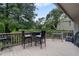 Spacious deck with seating area, grill, and tranquil wooded views at 303 Old Mill Pond Rd # 303, Palm Harbor, FL 34683
