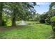Serene pond with fountain and lush landscaping at 303 Old Mill Pond Rd # 303, Palm Harbor, FL 34683