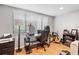 Home office with desk, chair, and window with blinds at 303 Old Mill Pond Rd # 303, Palm Harbor, FL 34683