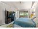 Main bedroom with a large bed, carpet and access to a private balcony at 303 Old Mill Pond Rd # 303, Palm Harbor, FL 34683