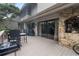 Large deck features stone fireplace and sliding glass doors at 303 Old Mill Pond Rd # 303, Palm Harbor, FL 34683