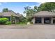 Two-car carport with building and landscaping in background at 303 Old Mill Pond Rd # 303, Palm Harbor, FL 34683