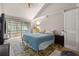 Main bedroom with a large bed, carpet, and access to a private balcony at 303 Old Mill Pond Rd # 303, Palm Harbor, FL 34683