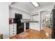 White kitchen features black appliances and opens to living area at 303 Old Mill Pond Rd # 303, Palm Harbor, FL 34683