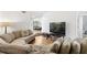 Spacious living room with large sectional sofa and hardwood floors at 303 Old Mill Pond Rd # 303, Palm Harbor, FL 34683