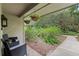 Cozy patio with seating and walkway to garden at 303 Old Mill Pond Rd # 303, Palm Harbor, FL 34683