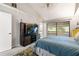 Main bedroom with a large bed, carpet and a view of the ensuite bathroom at 303 Old Mill Pond Rd # 303, Palm Harbor, FL 34683