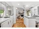 Kitchen with granite countertop, white cabinets and view of living room at 303 Old Mill Pond Rd # 303, Palm Harbor, FL 34683