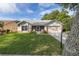 A charming one-story home with a two-car garage and lush green lawn at 1218 Gillespie N Dr, Palm Harbor, FL 34684