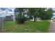 House front with a spacious lawn and mature trees at 3814 Holiday Lake Dr, Holiday, FL 34691