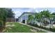 House exterior showcasing gray siding, patio furniture, and a grassy yard at 3814 Holiday Lake Dr, Holiday, FL 34691