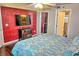 Cozy bedroom features a flat-screen television and access to the ensuite bathroom at 2077 Wetland Pt # 1103, Lutz, FL 33558