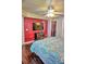 Cozy bedroom features a flat-screen television and a large mirrored closet at 2077 Wetland Pt # 1103, Lutz, FL 33558