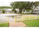 Charming community with manicured lawns, mature trees and yellow picket fence at 2077 Wetland Pt # 1103, Lutz, FL 33558